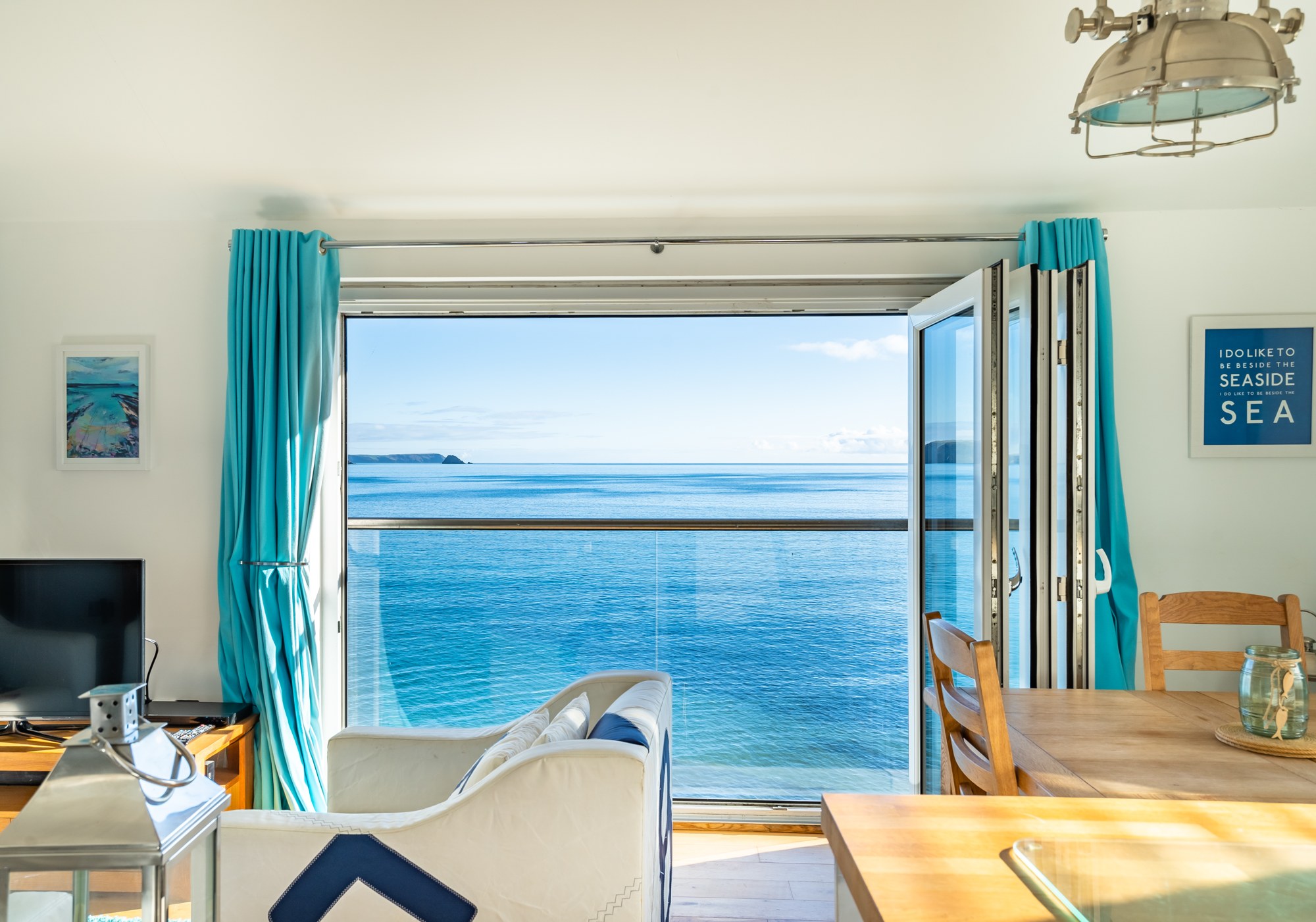 Top Deck's living room opening onto a sunlit sea view